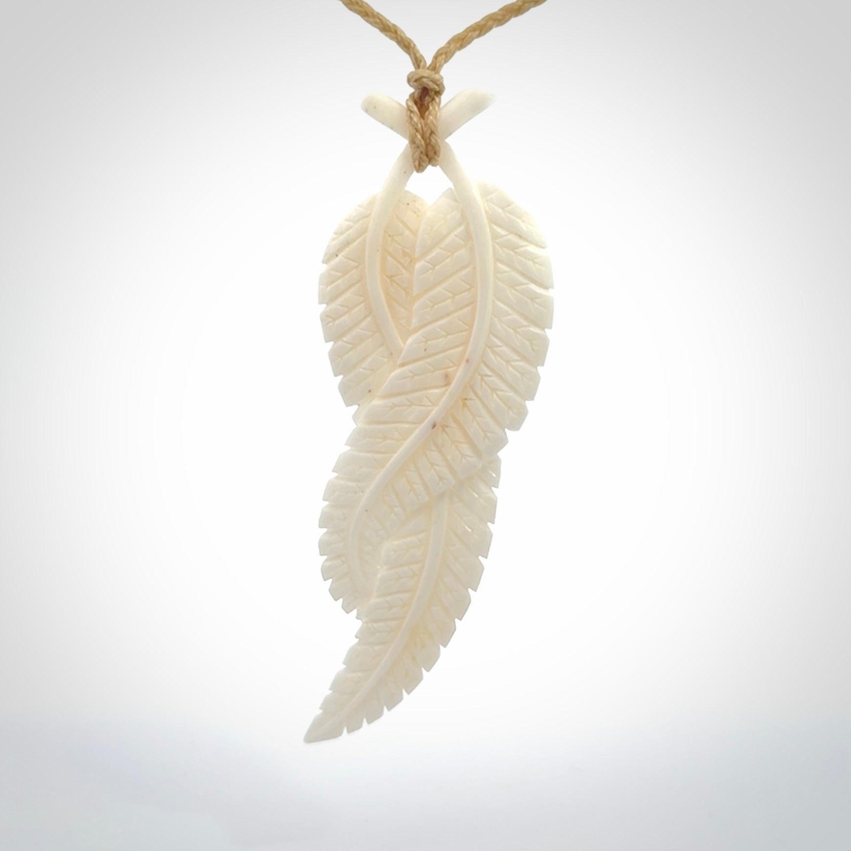 A hand carved large bone double fern leaf necklace. A beautiful large double fern leaf pendant carved from bone for NZ Pacific. This is a true piece of wearable art and is provided with an adjustable cord.