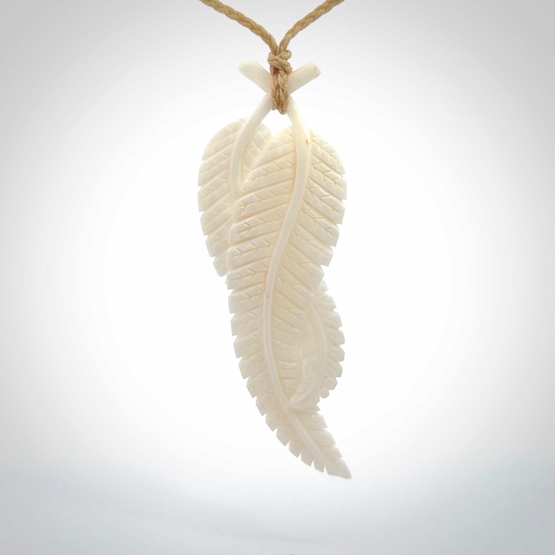A hand carved large bone double fern leaf necklace. A beautiful large double fern leaf pendant carved from bone for NZ Pacific. This is a true piece of wearable art and is provided with an adjustable cord.