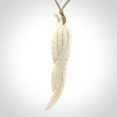 A hand carved large bone double fern leaf necklace. A beautiful large double fern leaf pendant carved from bone for NZ Pacific. This is a true piece of wearable art and is provided with an adjustable cord.