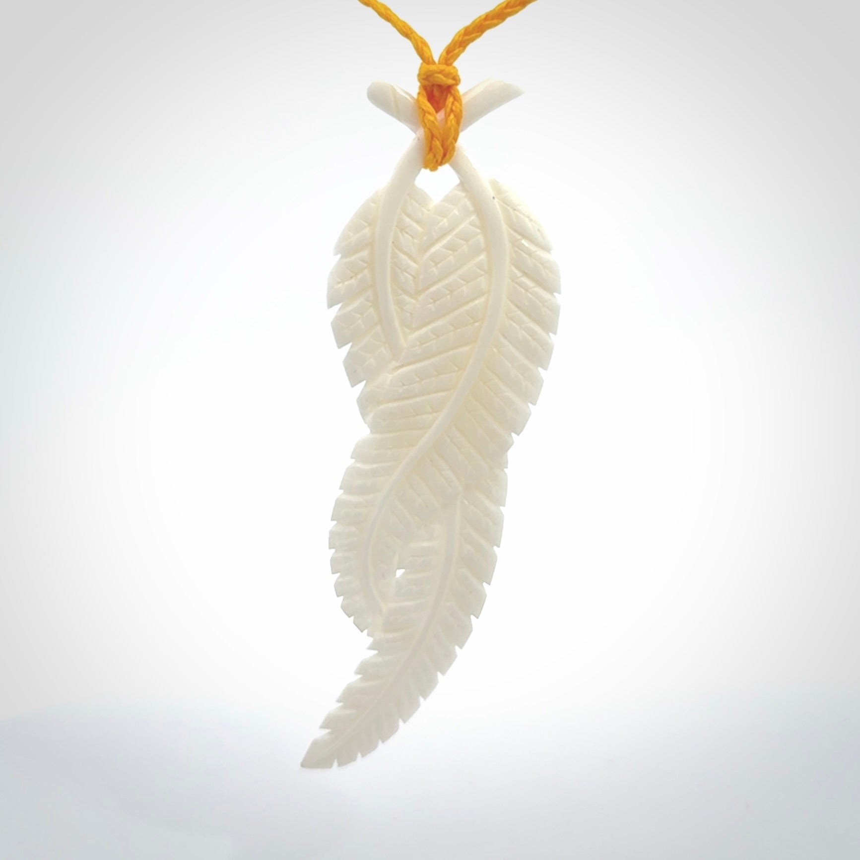 A hand carved large bone double fern leaf necklace. A beautiful large double fern leaf pendant carved from bone for NZ Pacific. This is a true piece of wearable art and is provided with an adjustable cord.