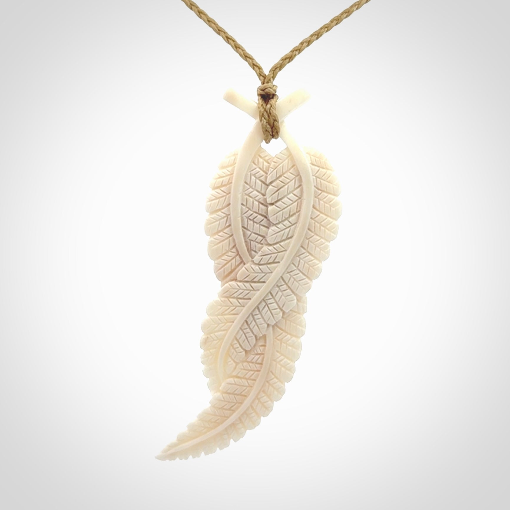 A hand carved large bone double fern leaf necklace. A beautiful large double fern leaf pendant carved from bone for NZ Pacific. This is a true piece of wearable art and is provided with an adjustable cord.