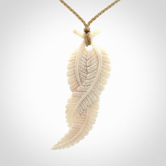 A hand carved large bone double fern leaf necklace. A beautiful large double fern leaf pendant carved from bone for NZ Pacific. This is a true piece of wearable art and is provided with an adjustable cord.
