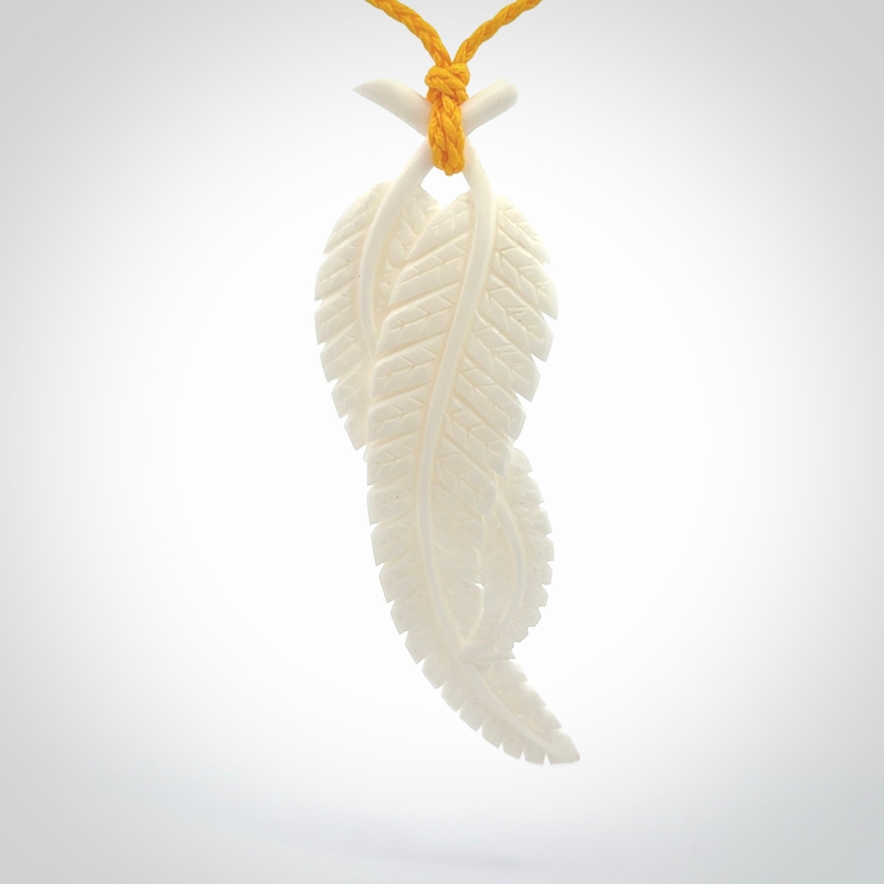 A hand carved large bone double fern leaf necklace. A beautiful large double fern leaf pendant carved from bone for NZ Pacific. This is a true piece of wearable art and is provided with an adjustable cord.