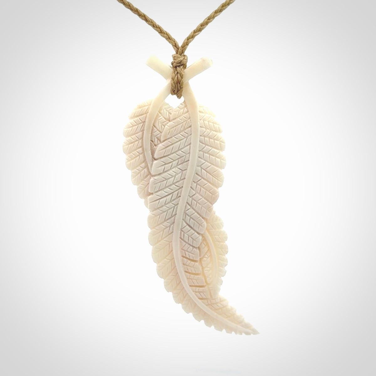 A hand carved large bone double fern leaf necklace. A beautiful large double fern leaf pendant carved from bone for NZ Pacific. This is a true piece of wearable art and is provided with an adjustable cord.