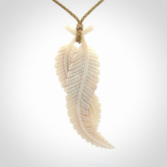 A hand carved large bone double fern leaf necklace. A beautiful large double fern leaf pendant carved from bone for NZ Pacific. This is a true piece of wearable art and is provided with an adjustable cord.