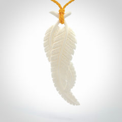 A hand carved large bone double fern leaf necklace. A beautiful large double fern leaf pendant carved from bone for NZ Pacific. This is a true piece of wearable art and is provided with an adjustable cord.