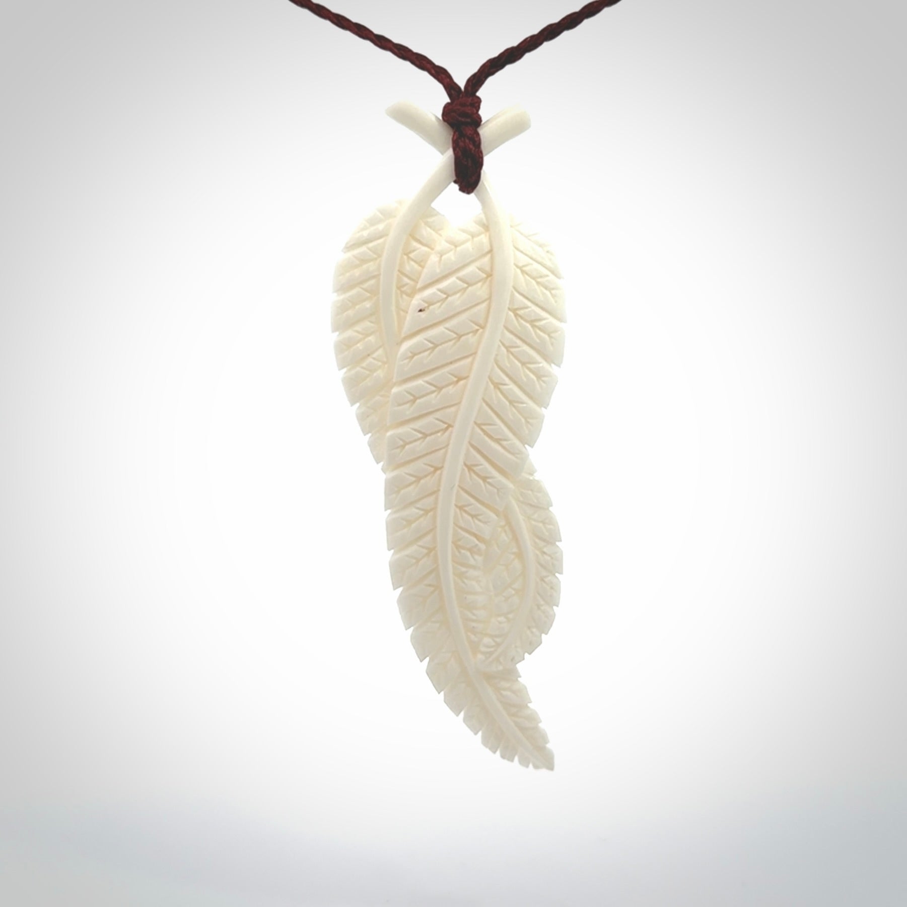 A hand carved large bone double fern leaf necklace. A beautiful large double fern leaf pendant carved from bone for NZ Pacific. This is a true piece of wearable art and is provided with an adjustable cord.
