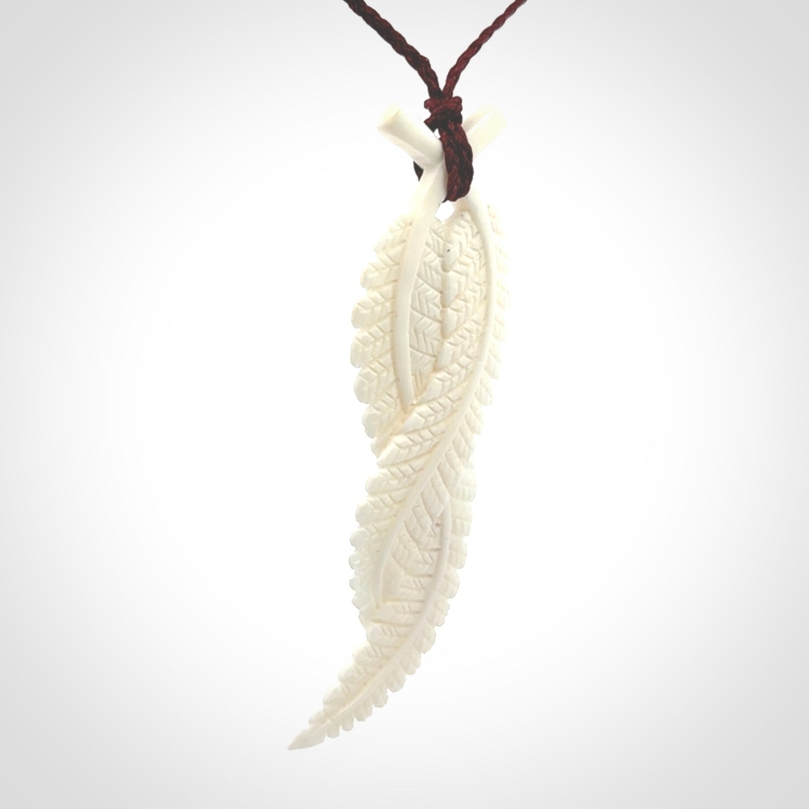 A hand carved large bone double fern leaf necklace. A beautiful large double fern leaf pendant carved from bone for NZ Pacific. This is a true piece of wearable art and is provided with an adjustable cord.