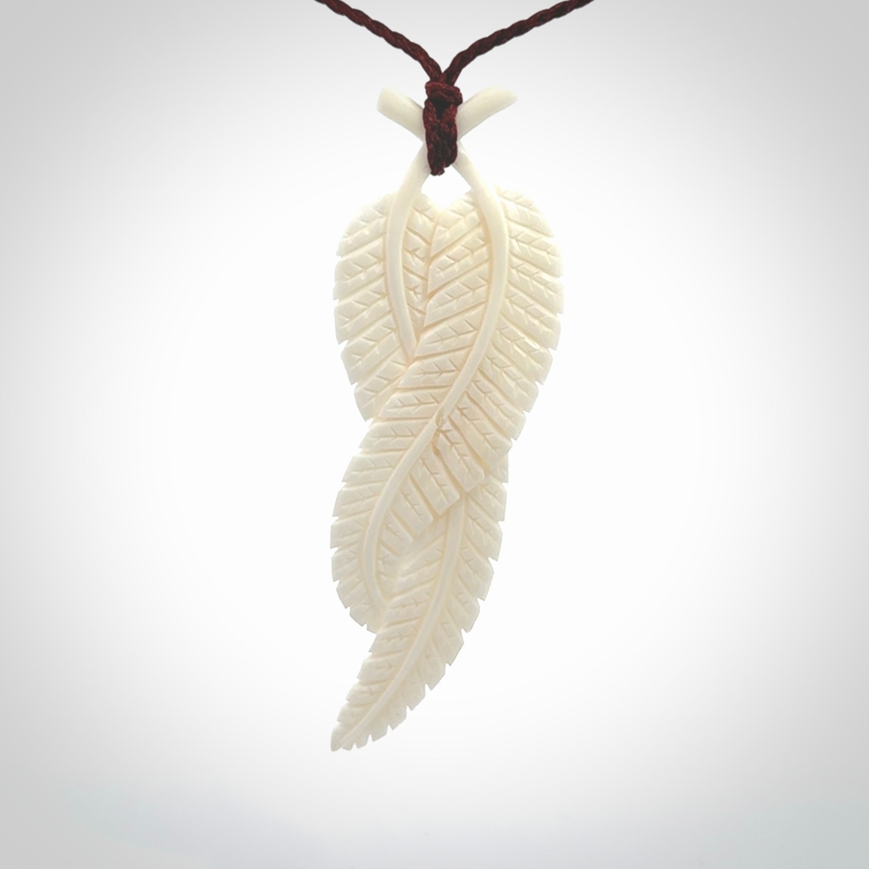 A hand carved large bone double fern leaf necklace. A beautiful large double fern leaf pendant carved from bone for NZ Pacific. This is a true piece of wearable art and is provided with an adjustable cord.