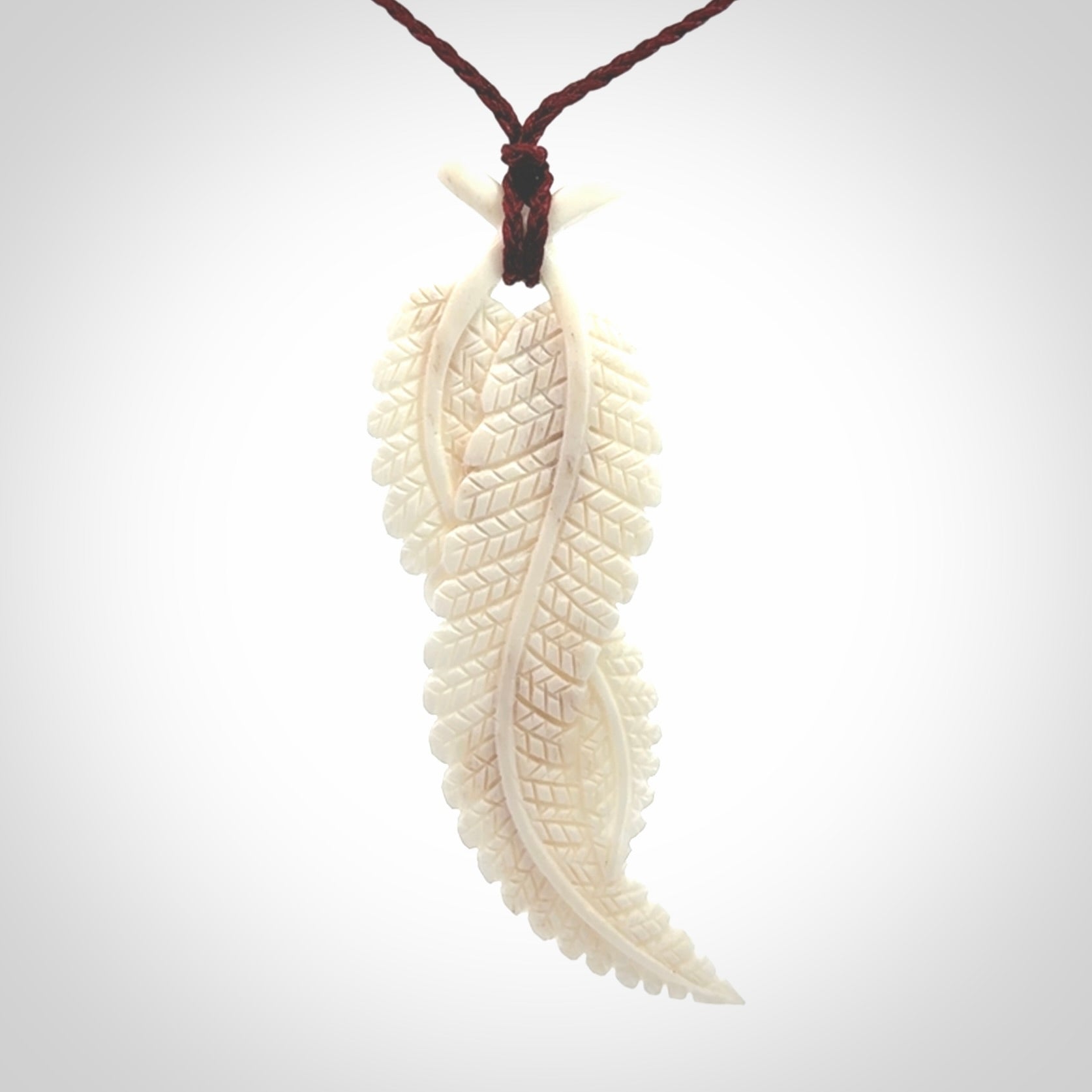 A hand carved large bone double fern leaf necklace. A beautiful large double fern leaf pendant carved from bone for NZ Pacific. This is a true piece of wearable art and is provided with an adjustable cord.