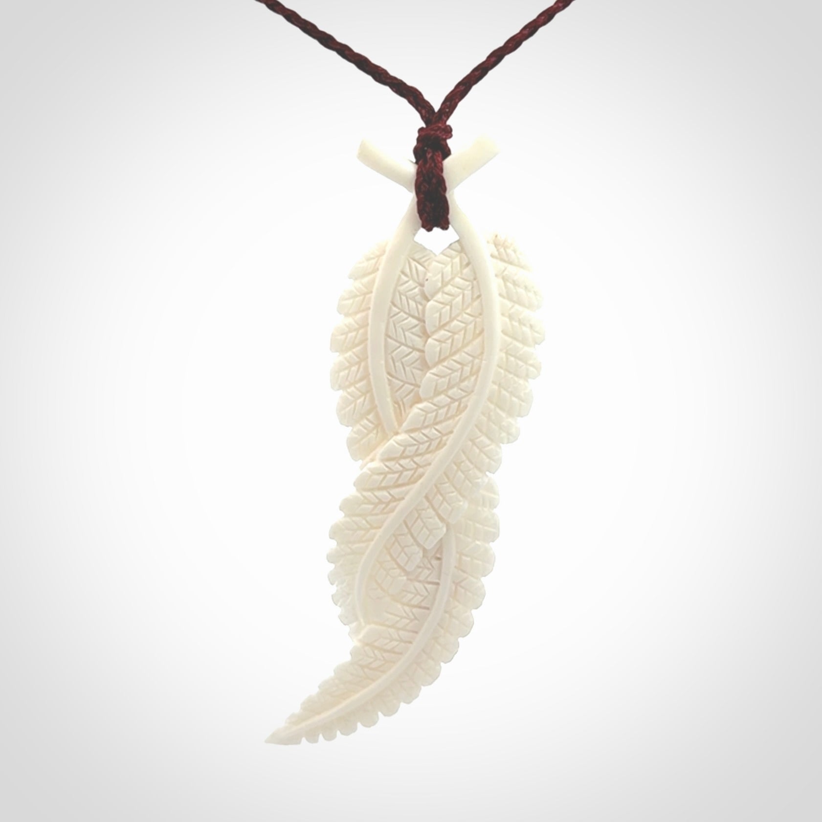 A hand carved large bone double fern leaf necklace. A beautiful large double fern leaf pendant carved from bone for NZ Pacific. This is a true piece of wearable art and is provided with an adjustable cord.