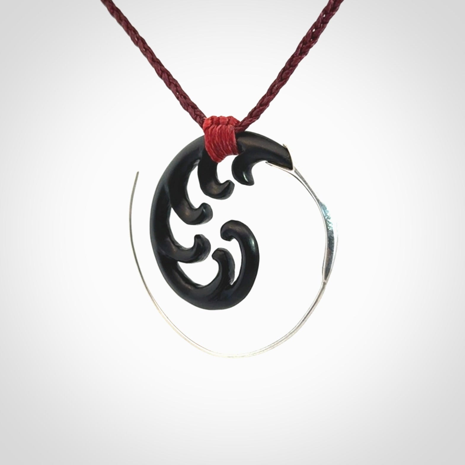 Hand carved pendant made from black jade with sterling silver. NZ Pacific contemporary Koru pendant for sale online.