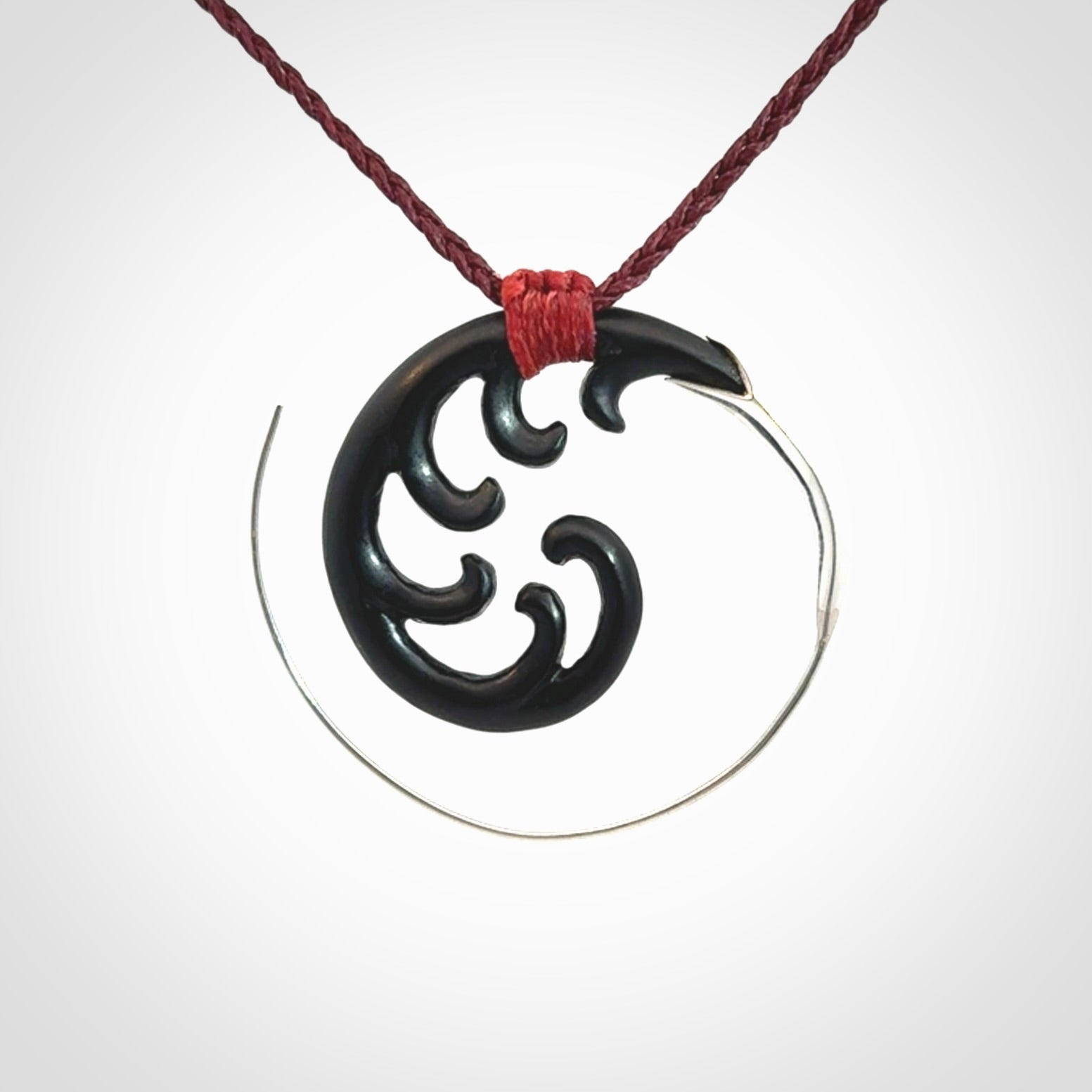 Hand carved pendant made from black jade with sterling silver. NZ Pacific contemporary Koru pendant for sale online.