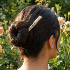 Woman wearing a hair pin in a bun hair style
