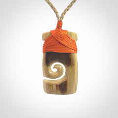 Hand carved Woolly Mammoth Tusk toki with koru pendant. Toki with koru necklace carved from ancient woolly mammoth tusk. Provided with adjustable cord and packaged in a woven kete pouch.