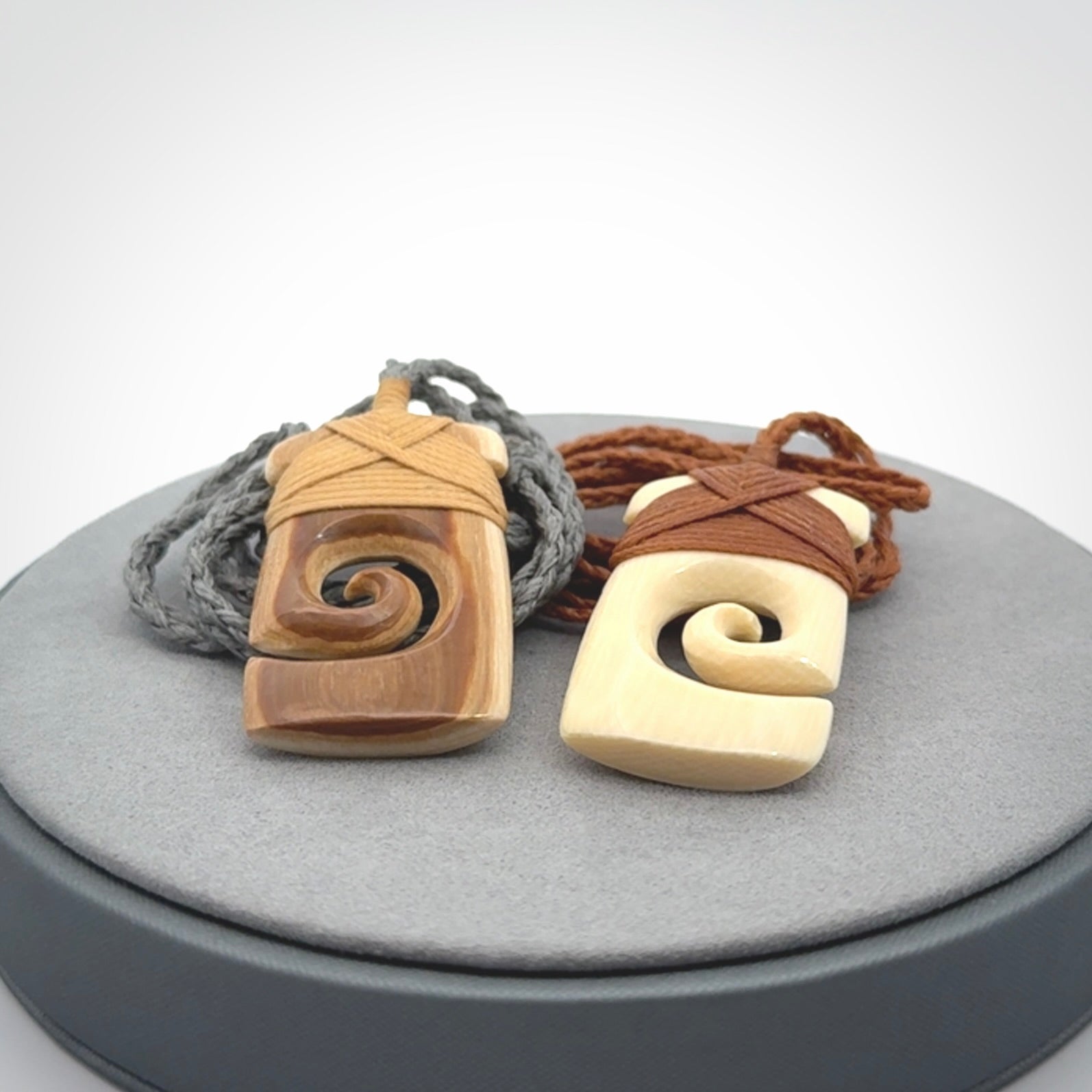 Hand carved Woolly Mammoth Tusk toki with koru pendant. Toki with koru necklace carved from ancient woolly mammoth tusk. Provided with adjustable cord and packaged in a woven kete pouch.