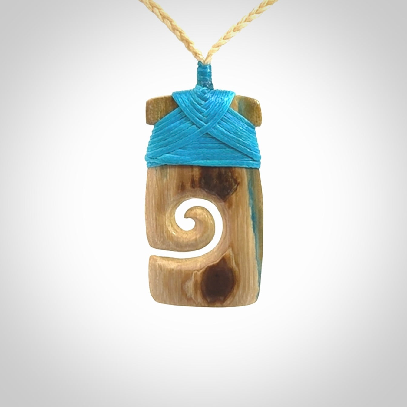 Hand carved Woolly Mammoth Tusk toki with koru pendant. Toki with koru necklace carved from ancient woolly mammoth tusk. Provided with adjustable cord and packaged in a woven kete pouch.