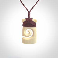 Hand carved Woolly Mammoth Tusk toki with koru pendant. Toki with koru necklace carved from ancient woolly mammoth tusk. Provided with adjustable cord and packaged in a woven kete pouch.