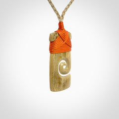 Hand carved Woolly Mammoth Tusk toki with koru pendant. Toki with koru necklace carved from ancient woolly mammoth tusk. Provided with adjustable cord and packaged in a woven kete pouch.