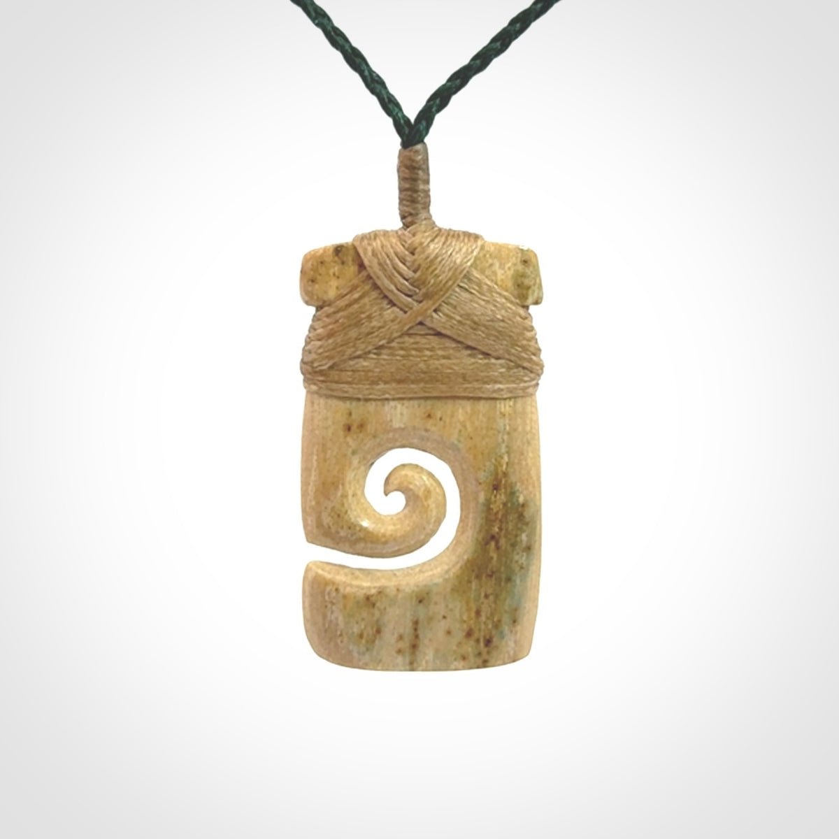 Hand carved Woolly Mammoth Tusk toki with koru pendant. Toki with koru necklace carved from ancient woolly mammoth tusk. Provided with adjustable cord and packaged in a woven kete pouch.