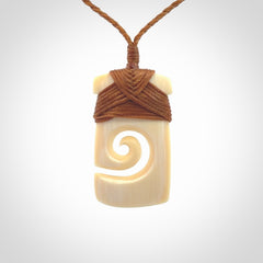 Hand carved Woolly Mammoth Tusk toki with koru pendant. Toki with koru necklace carved from ancient woolly mammoth tusk. Provided with adjustable cord and packaged in a woven kete pouch.