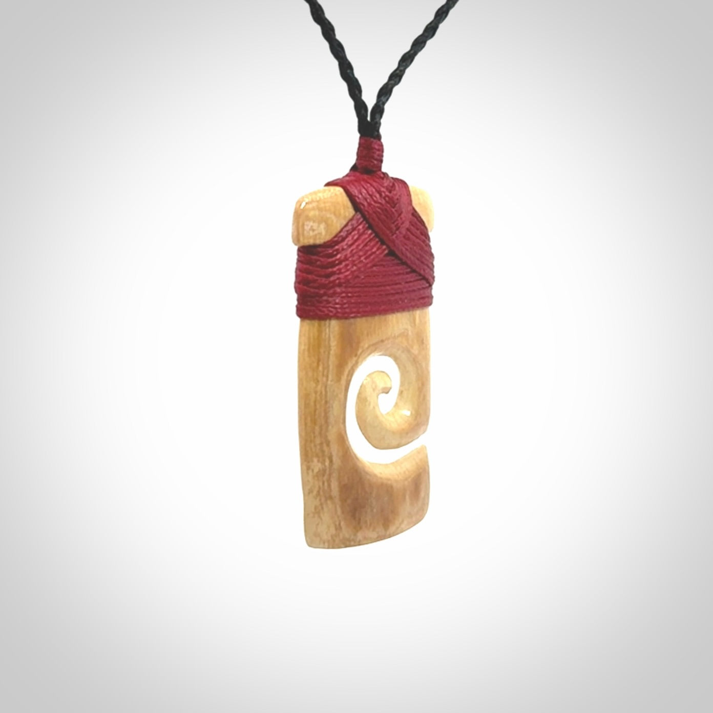Hand carved Woolly Mammoth Tusk toki with koru pendant. Toki with koru necklace carved from ancient woolly mammoth tusk. Provided with adjustable cord and packaged in a woven kete pouch.