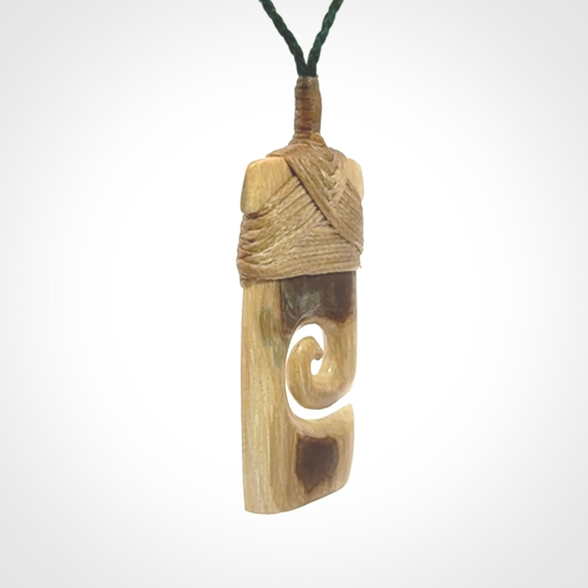Hand carved Woolly Mammoth Tusk toki with koru pendant. Toki with koru necklace carved from ancient woolly mammoth tusk. Provided with adjustable cord and packaged in a woven kete pouch.
