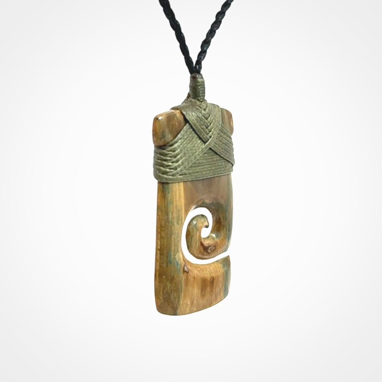 Hand carved Woolly Mammoth Tusk toki with koru pendant. Toki with koru necklace carved from ancient woolly mammoth tusk. Provided with adjustable cord and packaged in a woven kete pouch.