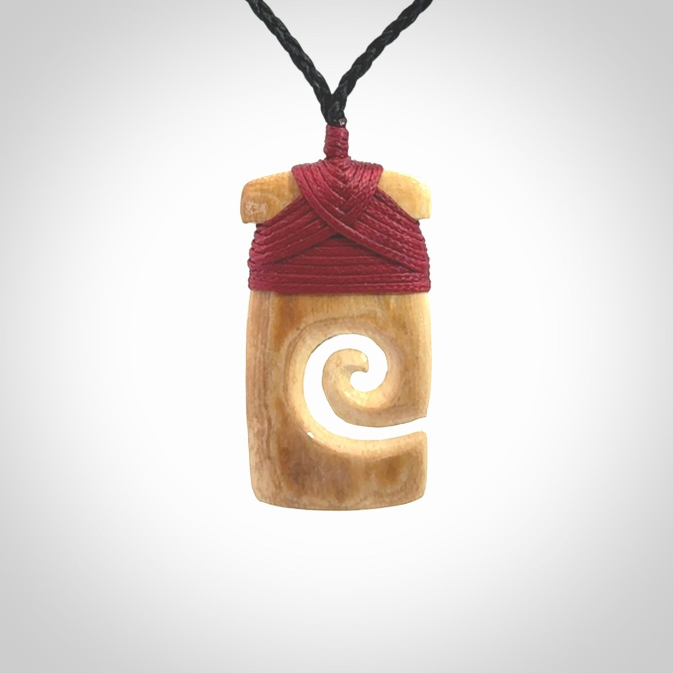 Hand carved Woolly Mammoth Tusk toki with koru pendant. Toki with koru necklace carved from ancient woolly mammoth tusk. Provided with adjustable cord and packaged in a woven kete pouch.