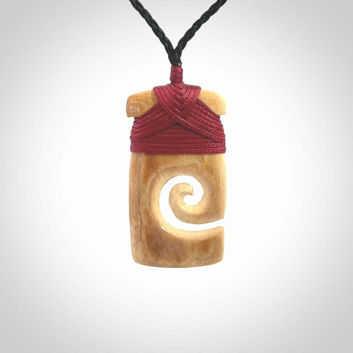 Hand carved Woolly Mammoth Tusk toki with koru pendant. Toki with koru necklace carved from ancient woolly mammoth tusk. Provided with adjustable cord and packaged in a woven kete pouch.