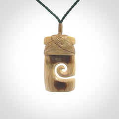 Hand carved Woolly Mammoth Tusk toki with koru pendant. Toki with koru necklace carved from ancient woolly mammoth tusk. Provided with adjustable cord and packaged in a woven kete pouch.