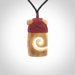 Hand carved Woolly Mammoth Tusk toki with koru pendant. Toki with koru necklace carved from ancient woolly mammoth tusk. Provided with adjustable cord and packaged in a woven kete pouch.