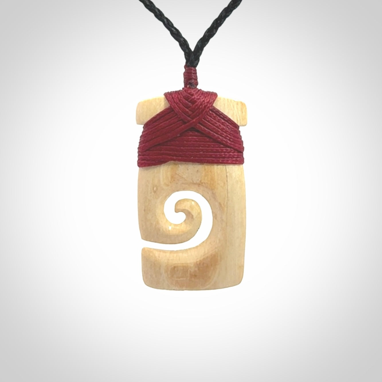 Hand carved Woolly Mammoth Tusk toki with koru pendant. Toki with koru necklace carved from ancient woolly mammoth tusk. Provided with adjustable cord and packaged in a woven kete pouch.