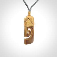 Hand carved Woolly Mammoth Tusk toki with koru pendant. Toki with koru necklace carved from ancient woolly mammoth tusk. Provided with adjustable cord and packaged in a woven kete pouch.