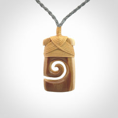 Hand carved Woolly Mammoth Tusk toki with koru pendant. Toki with koru necklace carved from ancient woolly mammoth tusk. Provided with adjustable cord and packaged in a woven kete pouch.