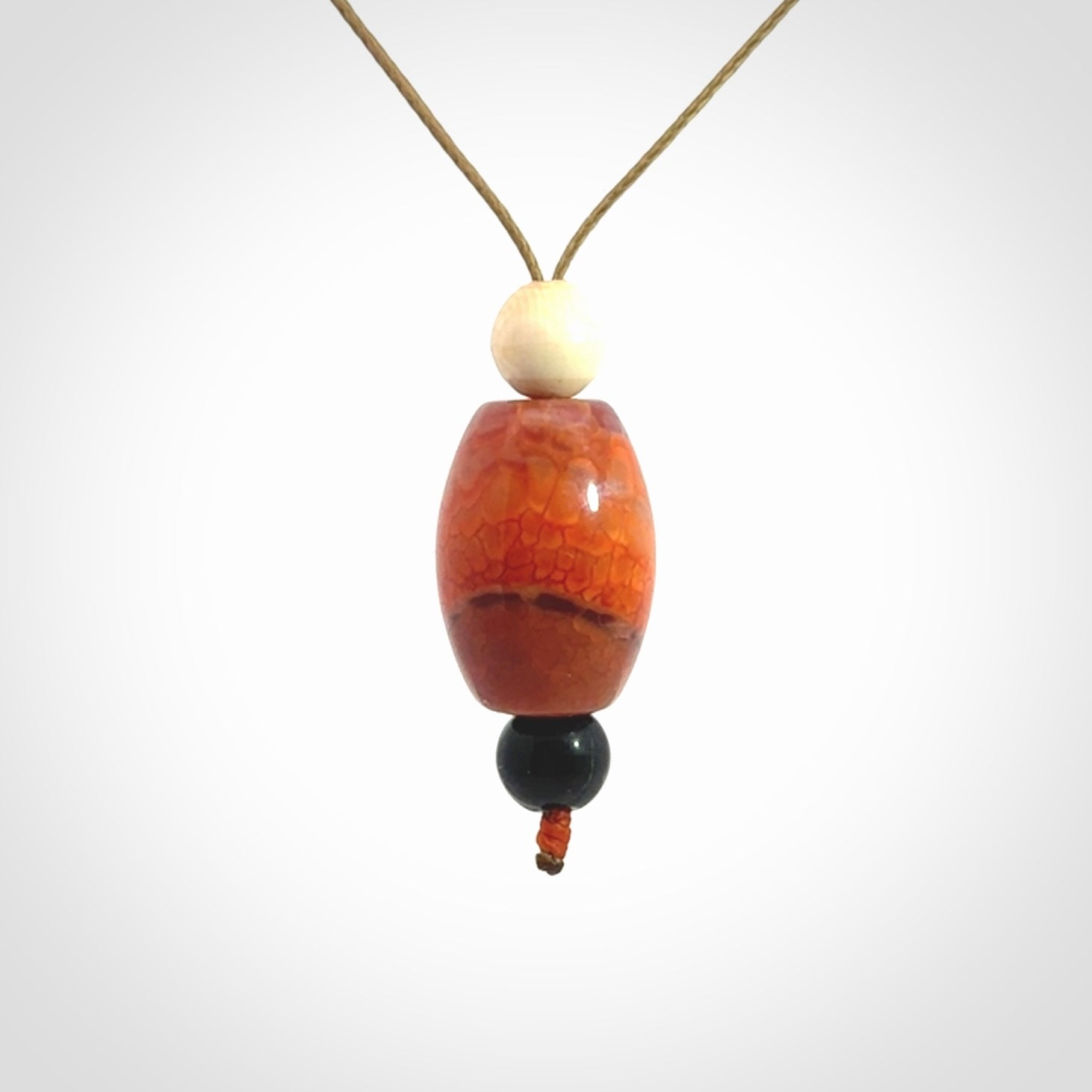 Snakeskin Agate contemporary drop pendant with black jade and woolly mammoth tusk beads. Hand carved for you by NZ Pacific.