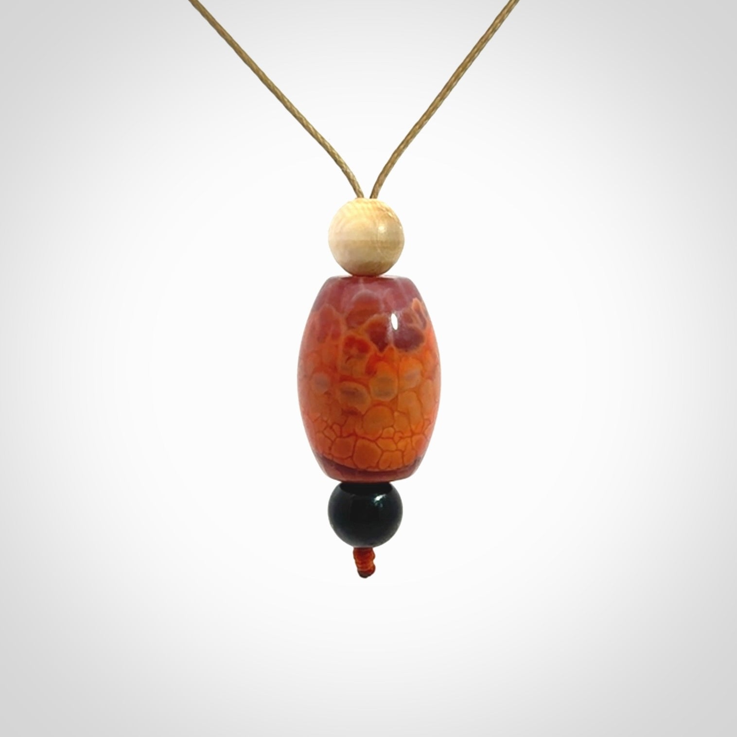 Snakeskin Agate contemporary drop pendant with black jade and woolly mammoth tusk beads. Hand carved for you by NZ Pacific.