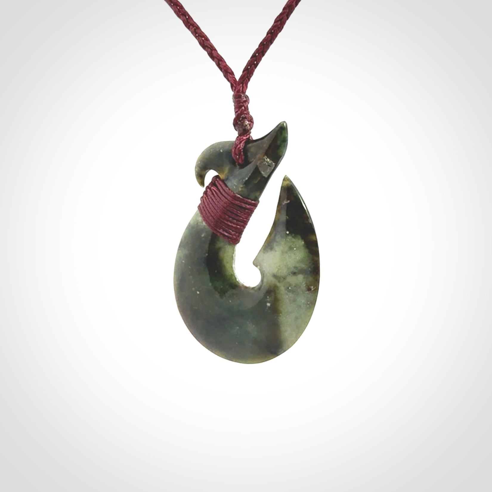 Hand carved New Zealand Jade Hook Pendant. Matau necklace hand carved. Jade Hook pendant provided with adjustable cord and packaged in a woven kete pouch. Delivered with Express Courier.