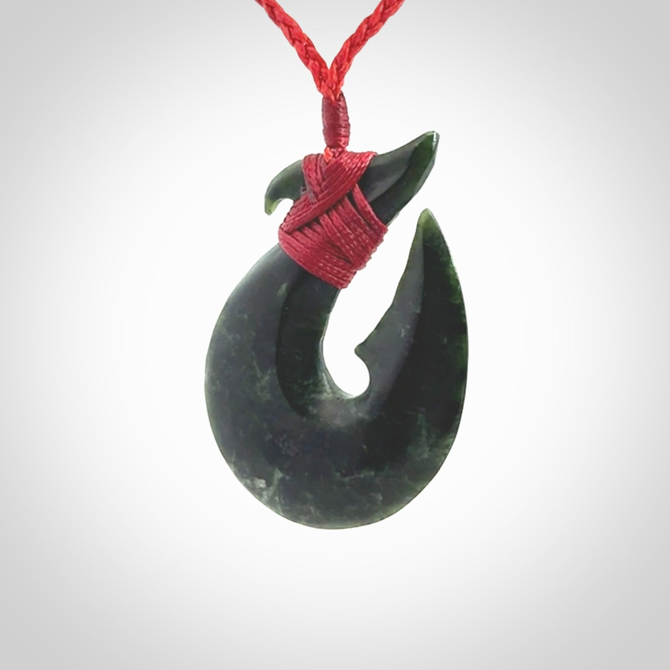 Hand carved New Zealand Jade Hook Pendant. Matau necklace hand carved. Jade Hook pendant provided with adjustable cord and packaged in a woven kete pouch. Delivered with Express Courier.