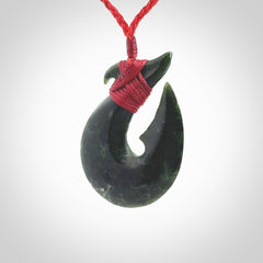 Hand carved New Zealand Jade Hook Pendant. Matau necklace hand carved. Jade Hook pendant provided with adjustable cord and packaged in a woven kete pouch. Delivered with Express Courier.