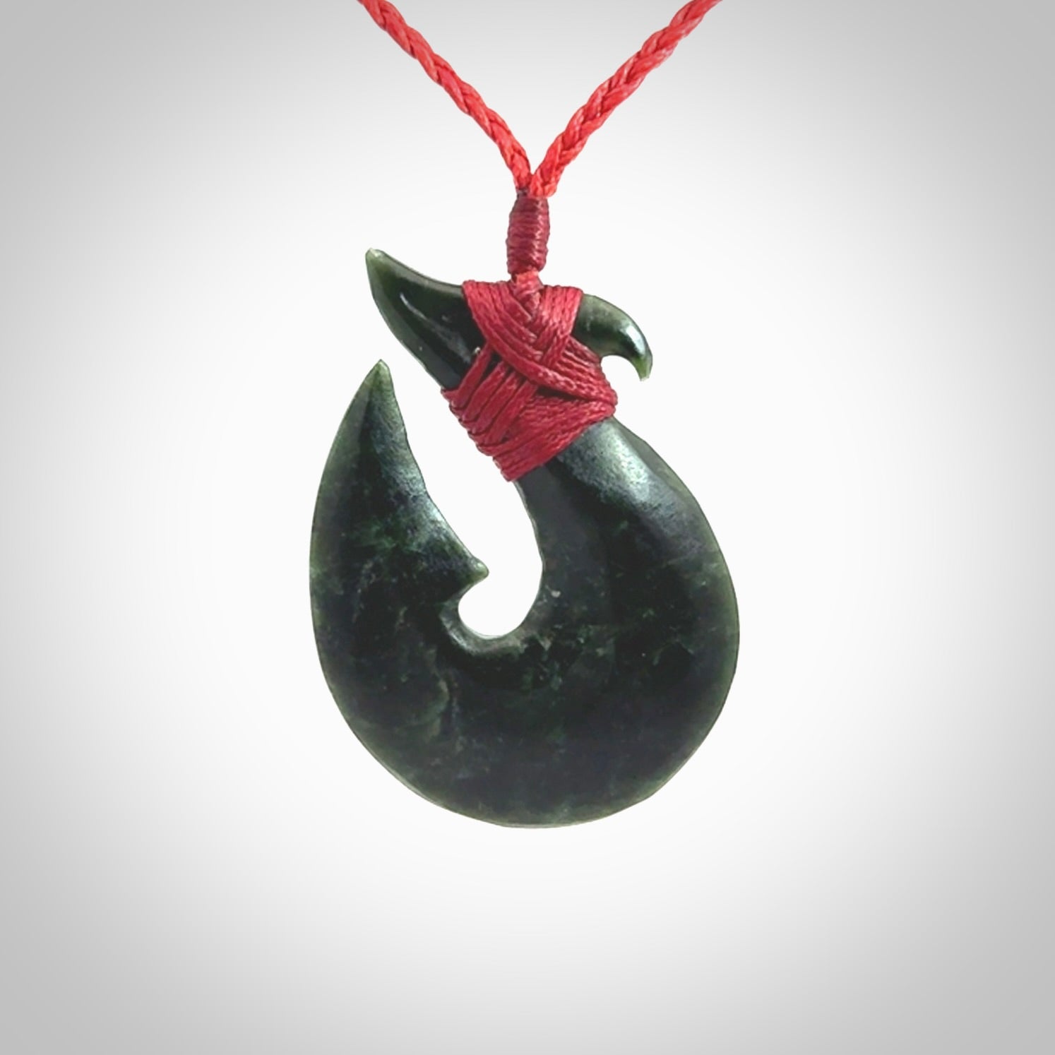 Hand carved New Zealand Jade Hook Pendant. Matau necklace hand carved. Jade Hook pendant provided with adjustable cord and packaged in a woven kete pouch. Delivered with Express Courier.