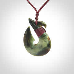 Hand carved New Zealand Jade Hook Pendant. Matau necklace hand carved. Jade Hook pendant provided with adjustable cord and packaged in a woven kete pouch. Delivered with Express Courier.