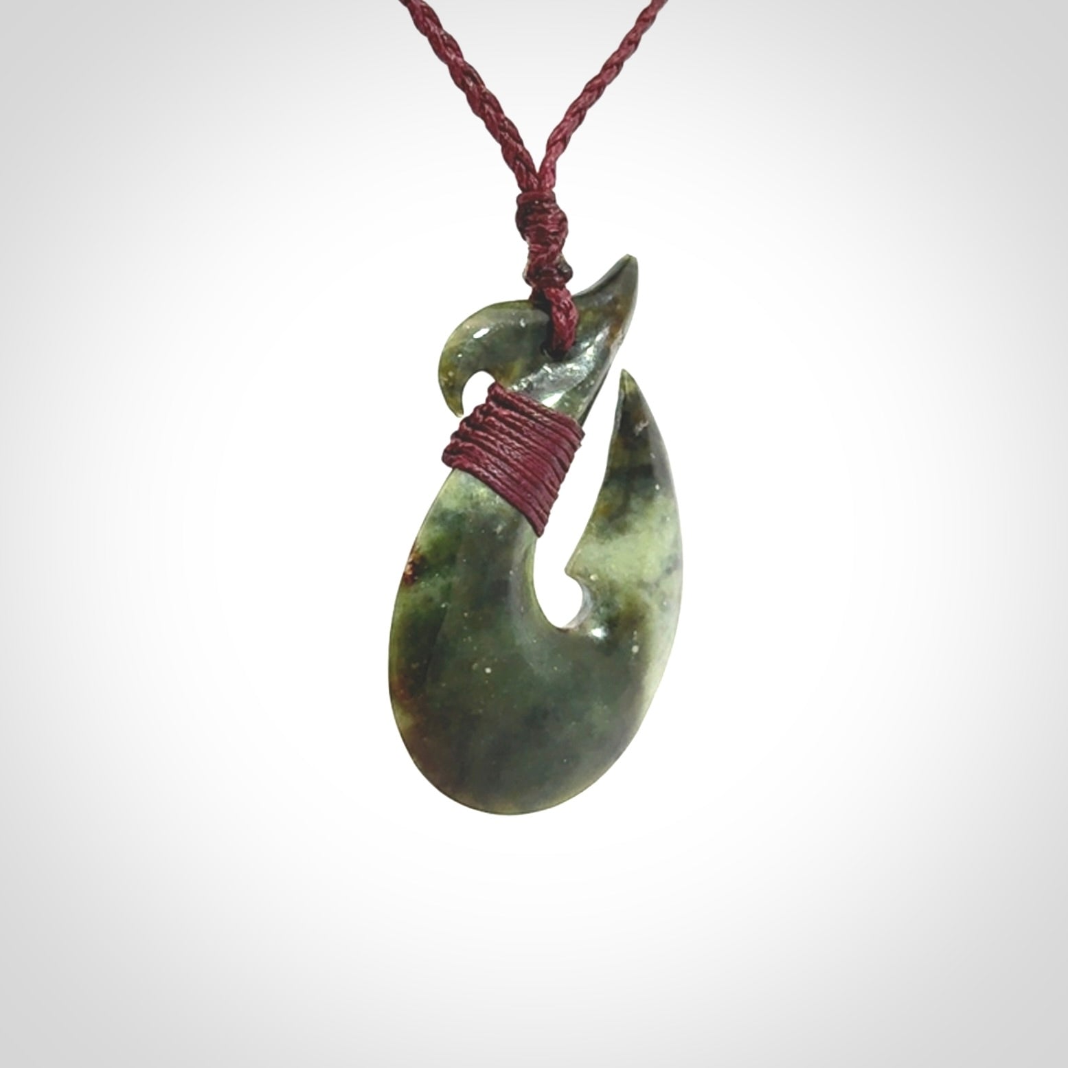 Hand carved New Zealand Jade Hook Pendant. Matau necklace hand carved. Jade Hook pendant provided with adjustable cord and packaged in a woven kete pouch. Delivered with Express Courier.