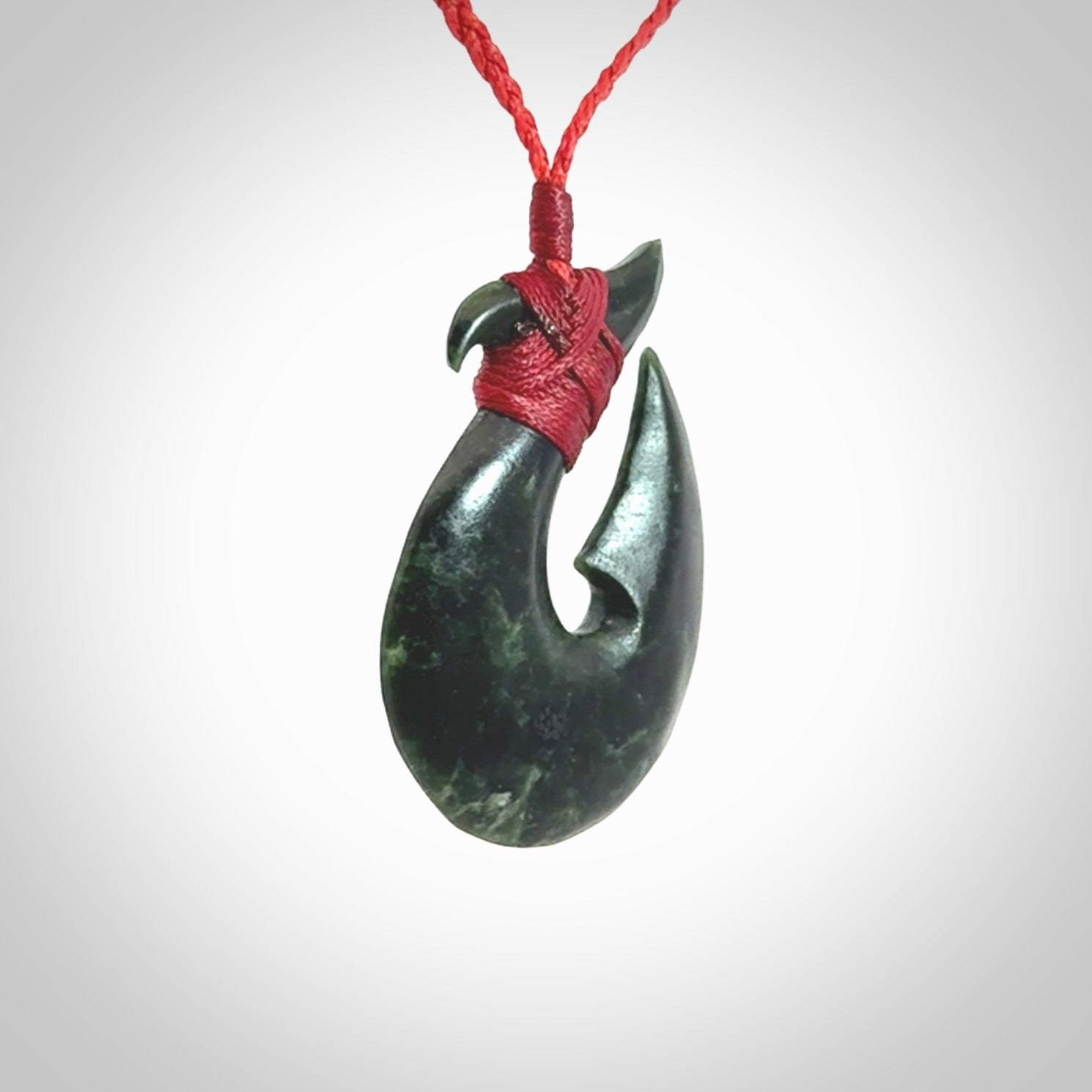 Hand carved New Zealand Jade Hook Pendant. Matau necklace hand carved. Jade Hook pendant provided with adjustable cord and packaged in a woven kete pouch. Delivered with Express Courier.