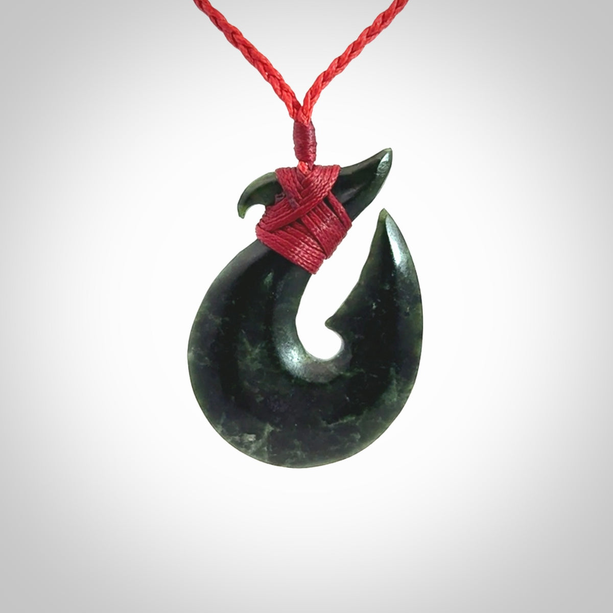 Hand carved New Zealand Jade Hook Pendant. Matau necklace hand carved. Jade Hook pendant provided with adjustable cord and packaged in a woven kete pouch. Delivered with Express Courier.