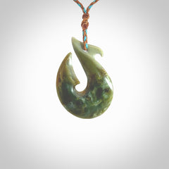 Hand carved New Zealand Jade Hook Pendant. Matau necklace hand carved. Jade Hook pendant provided with adjustable cord and packaged in a woven kete pouch. Delivered with Express Courier.