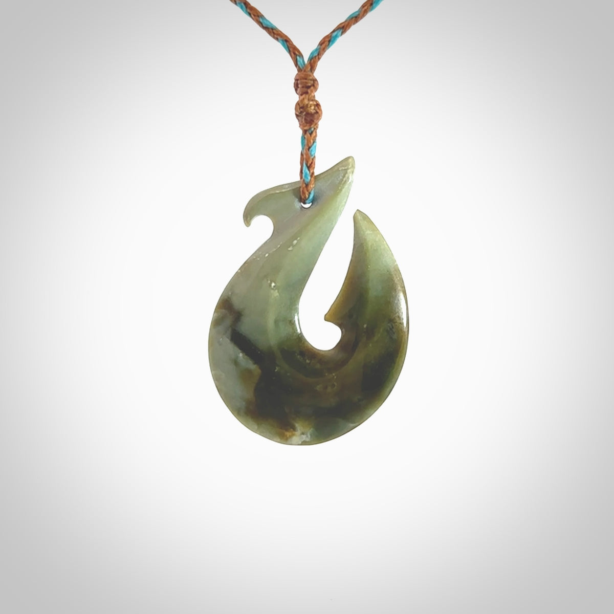 Hand carved New Zealand Jade Hook Pendant. Matau necklace hand carved. Jade Hook pendant provided with adjustable cord and packaged in a woven kete pouch. Delivered with Express Courier.