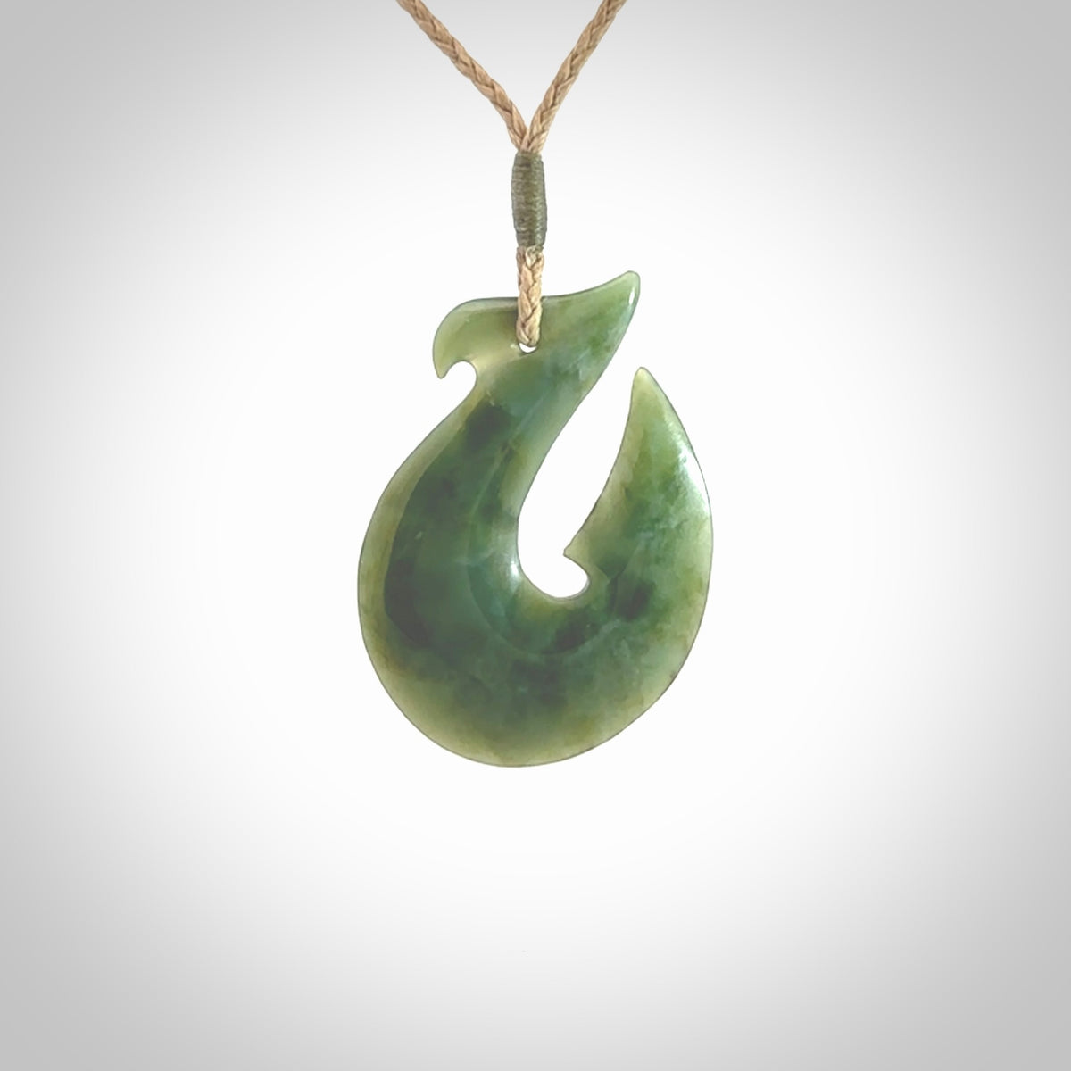 Hand carved New Zealand Jade Hook Pendant. Matau necklace hand carved. Jade Hook pendant provided with adjustable cord and packaged in a woven kete pouch. Delivered with Express Courier.