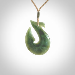 Hand carved New Zealand Jade Hook Pendant. Matau necklace hand carved. Jade Hook pendant provided with adjustable cord and packaged in a woven kete pouch. Delivered with Express Courier.