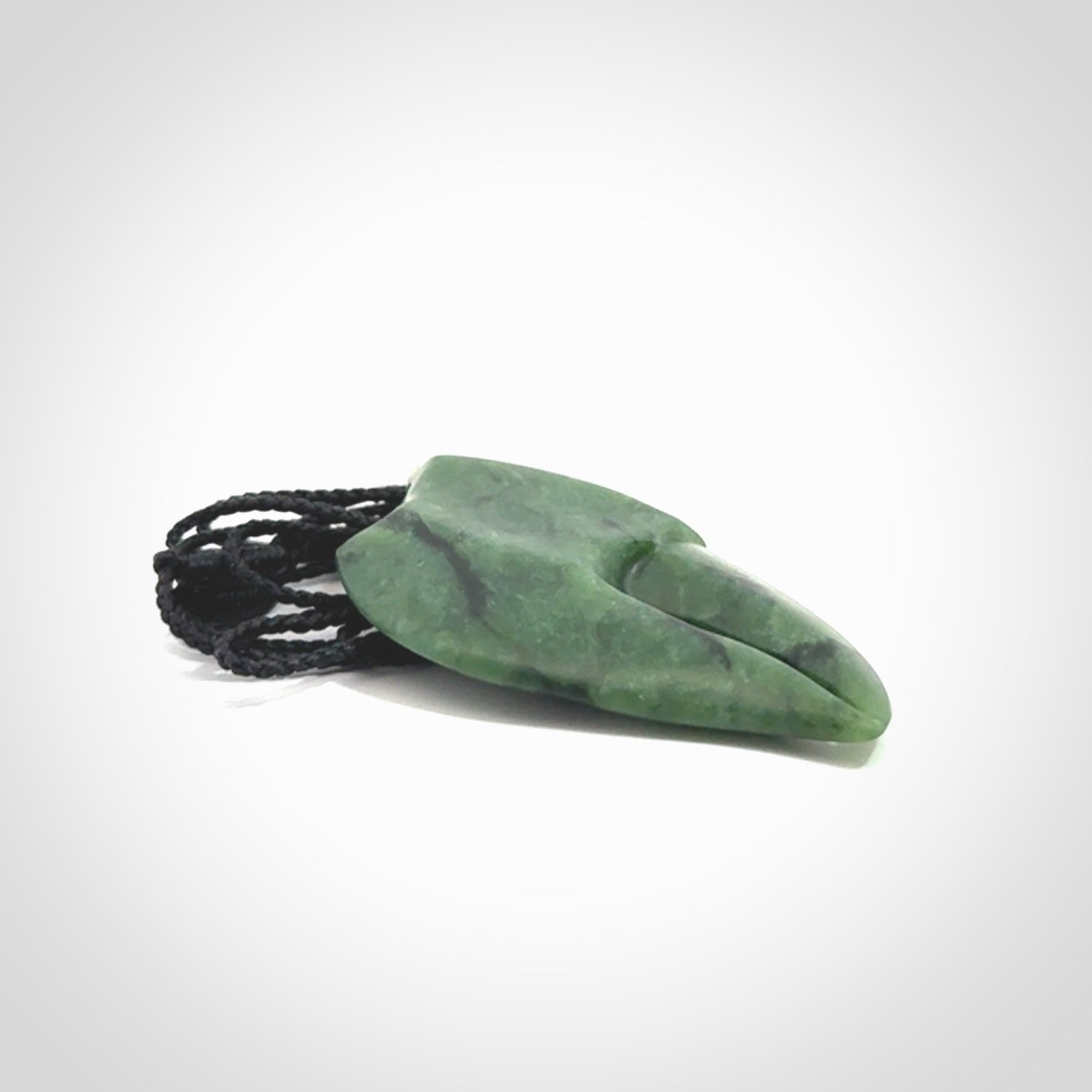 This large crab claw pendant is carved from a lovely deep green piece of New Zealand jade. It has an adjustable black coloured cord which can be slipped over the head and adjusted to the length that you prefer. Hand carved in New Zealand from our local jade by Kyohei Noguchi.